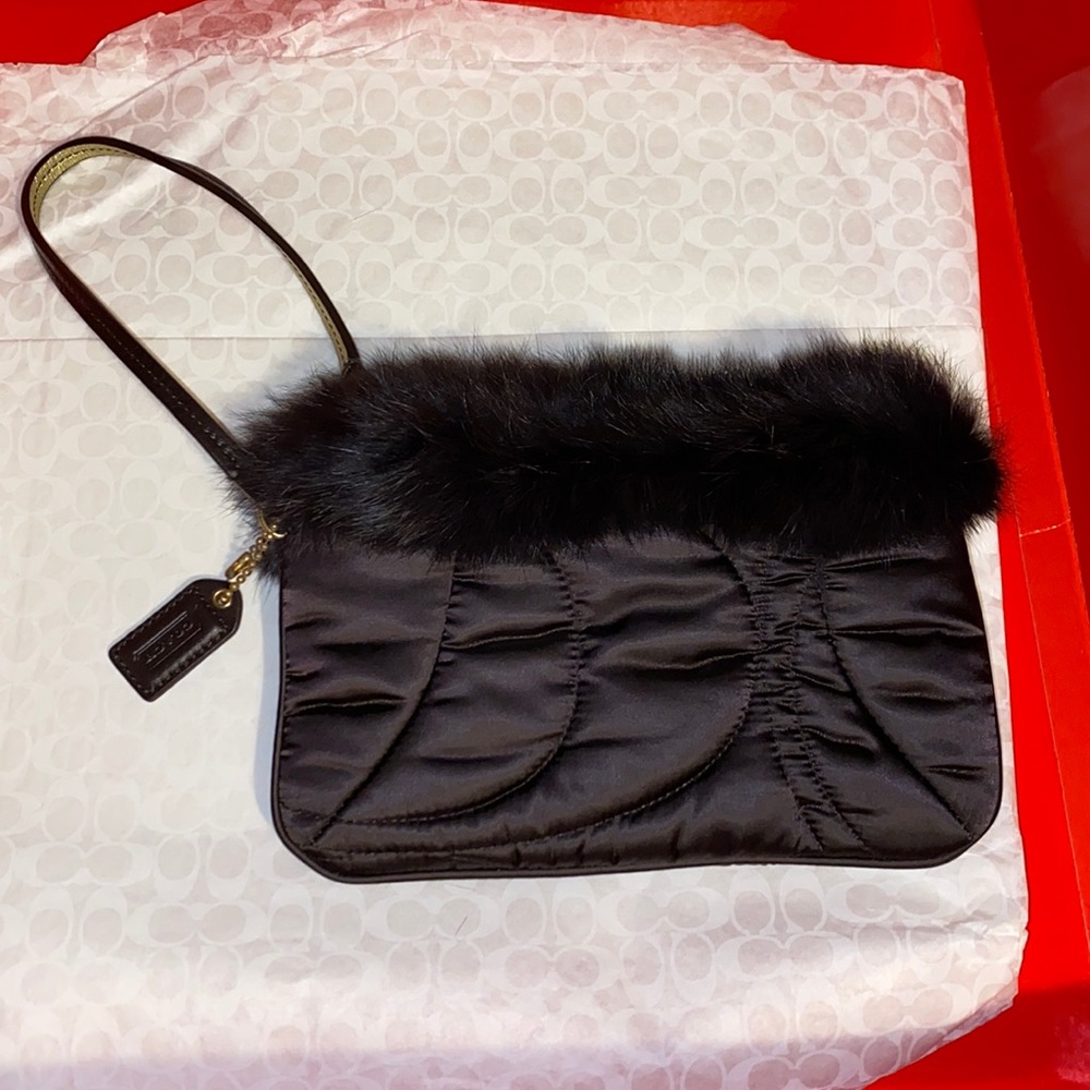 Coach signature fur trimmed zippered wristlet.